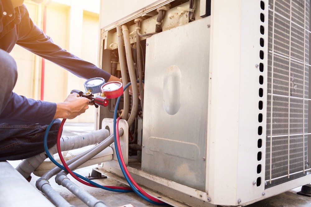 Technician is checking air conditioner ,measuring equipment for filling air conditioners. climatisation lyon